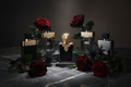 Premium men's luxury fragrance collection on dark marble with roses